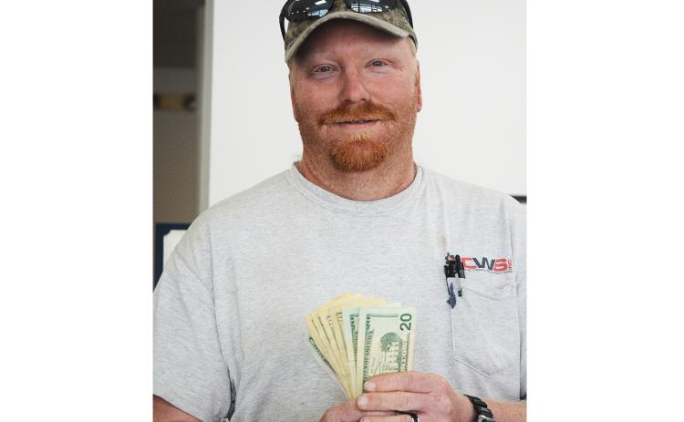 Sunshot by Michael Hall — Josh Owen shows off the $100 he won by submitting the winning photo for the Hello Hart cover photo contest.