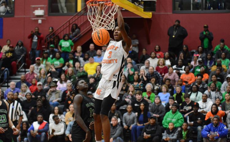 Sunshot by Grayson Williams Hart County’s Tahj Johnson throws down a dunk during the region tournament at Emmanuel College in February. Johnson named class AAA freshman of the year by two recruiting websites.