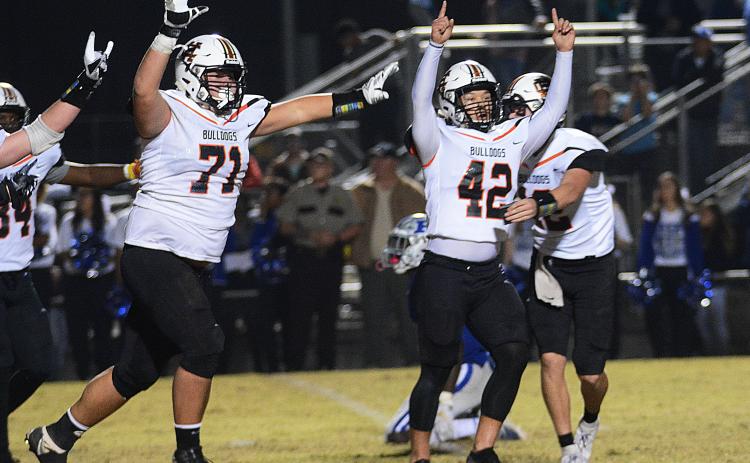 Sunshot by Michael Hall — Hart County kicker Tucker Kim, No. 42, raises his hands in victory along with Caden Hart, No. 71, while quarterback Luke Lee tackles Kim after Kim’s game winning field goal on Nov. 22, 2019 in Blackshear over the Pierce County Bears.