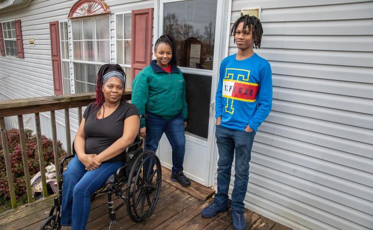 Photo by Stephanie Crump — Yolanda Feaster, left, poses for a photo with her children, Queasia, middle, and C.J., right.