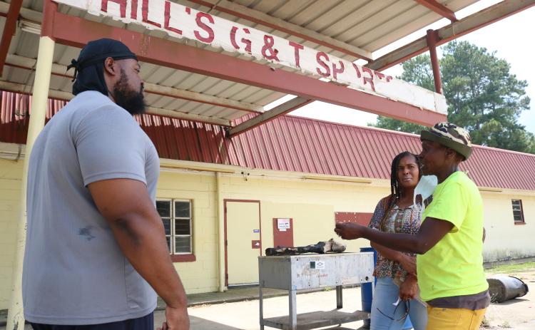 Sunshot by Grayson Williams — Pastor Frederick Vehe, left, Keesha Oglesby, center and Darlene Smith-Neal talk about their plans outside of the vacant G&T Snack Bar recently.