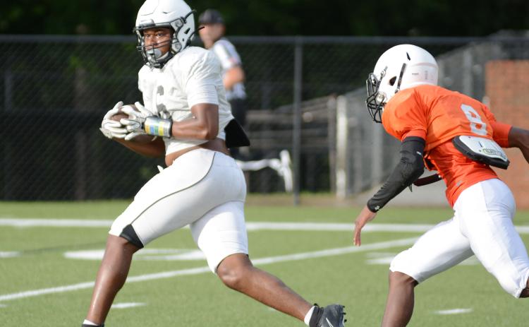 Sunshot by Grayson Williams - Receiver Malachi Kelley looks for running room up field after making a catch during the Bulldogs’ intrasquad scrimmage on Aug. 21 at Herndon Stadium.