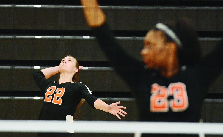 Sunshot by Michael Hall - Madison Wolfe serves during the Hart County Volleyball team’s win over Rabun County on Aug. 20 as LaMaya Sessoms prepares for action.