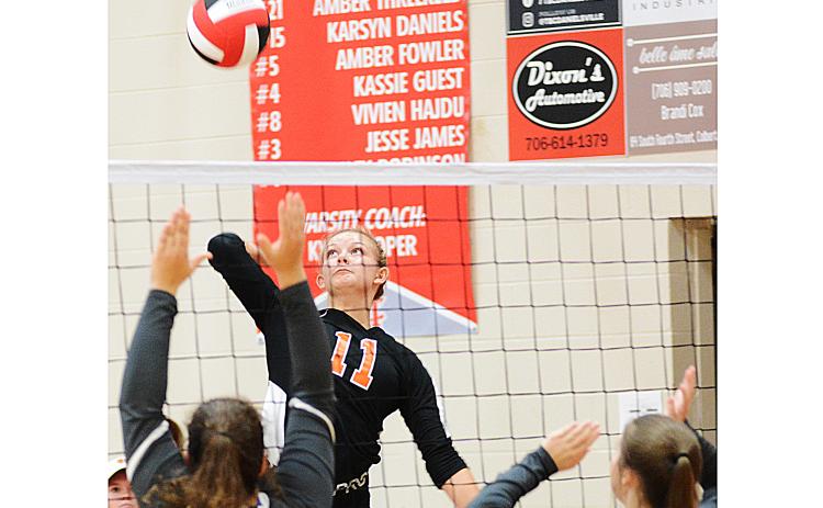 Sunshot by Michael Hall — Alex Burdette spikes the ball against Madison County at the Madison County Round Robin Tournament at Madison County High School on Saturday, Aug. 15.
