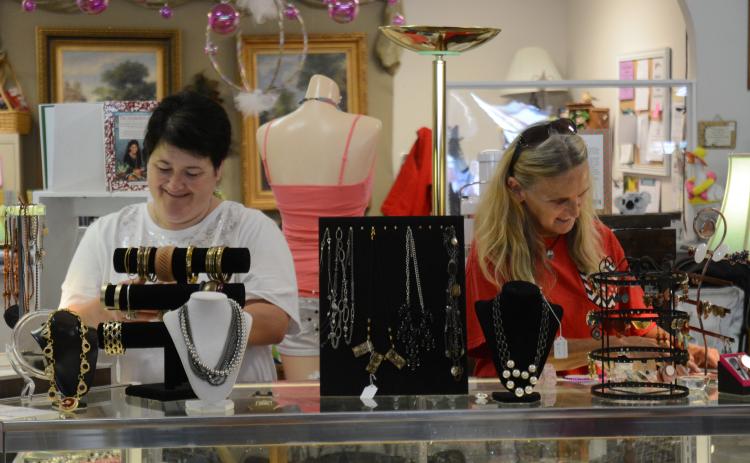 Sunshot by Michael Hall - Carrie Ingram, left, a volunteer for the Northeast Georgia Council on Domestic Violence, and April Boleman, right, manager of South Forest Station, work at South Forest Station recently. The thrift and consignment shop in downtown Hartwell is a program of the council and is in need of volunteers.