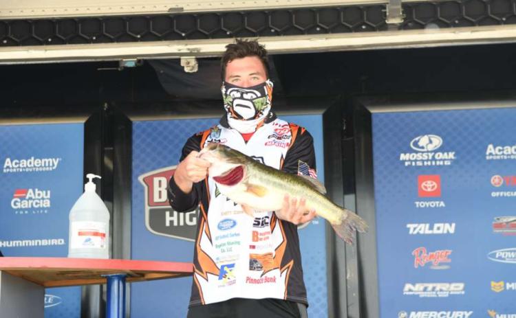 Photo submitted - Dawson Carden shows off the second-biggest fish of the tournament, a 5-lbs., 6-oz., largemouth at weigh in of the Mossy Oak Fishing Bassmaster High School Series.