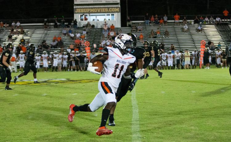 Photo submited by Davontay Wilson - Hart County’s Paul Davis tries to get around the edge after a catch on Friday, Sept. 4, against Wayne County in Jesup. The Bulldogs fell in their opener to the Yellow Jackets, 29-13.