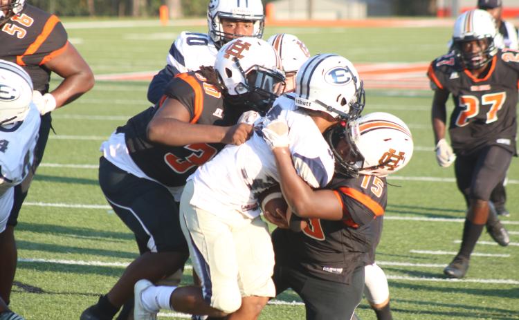 Pictured, several Bulldogs take down a Blue Devil ball carrier.