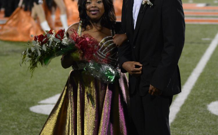 Taylor Freeman, left, smiles with her father and escort, Tyler Freeman, after being crowned the 2020 Homecoming Queen for Hart County High School on Friday, Oct. 16, at Herndon Stadium.