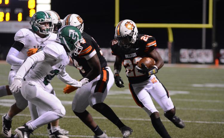 Sunshots by Grayson Williams Running back Nori Moore prepares for contact with a Franklin County defender on Friday, Oct. 16, at Herndon Stadium in the Bulldogs’ homecoming victory over the Lions.