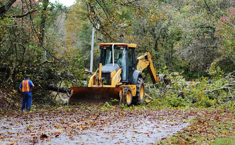 Sunshot by Michael Hall - A Hart County road crew clears a large tree that fell across Payne’s Creek Road on Oct. 29 after Tropical Storm Zeta passed through the area.