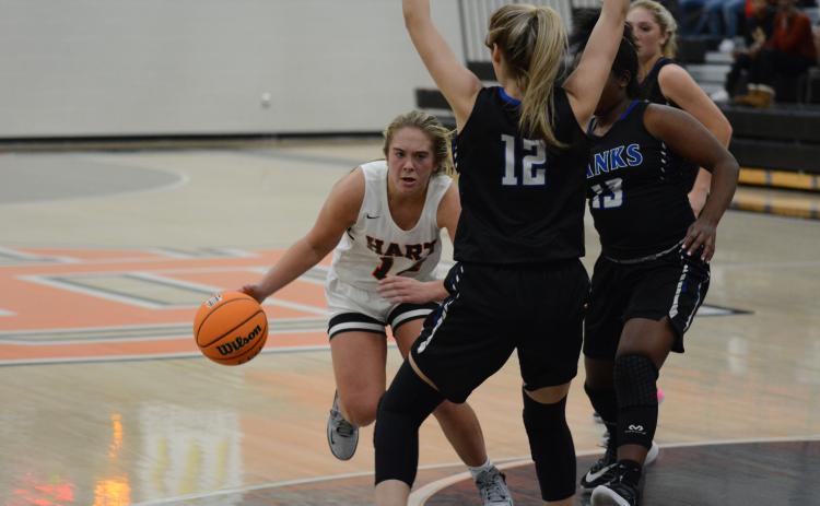 Sunshot by Grayson Williams Hart County’s Dakota Phillips dribbles around Banks County defenders in a scrimmage at Hart County High School on Nov. 17.