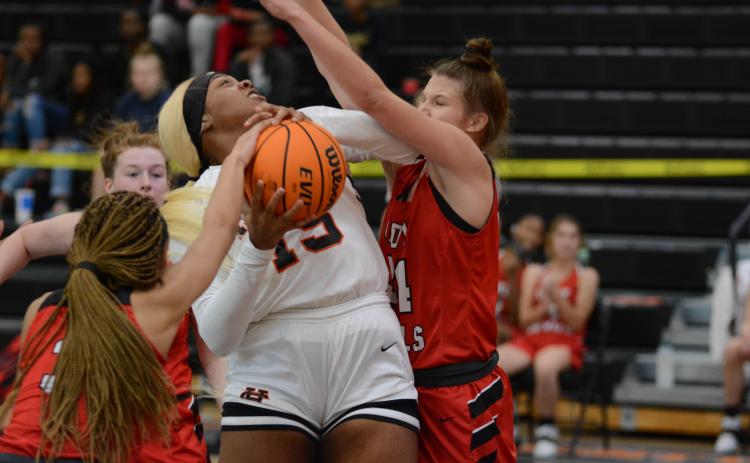 Sunshot by Grayson Williams - Taniya “Nesha” Alexander tries to power through Loganville defenders on Monday at Hart County High School during the McDonald’s Shootout. The Hart County Lady Dogs fell by one point on Tuesday in the semifinal game.