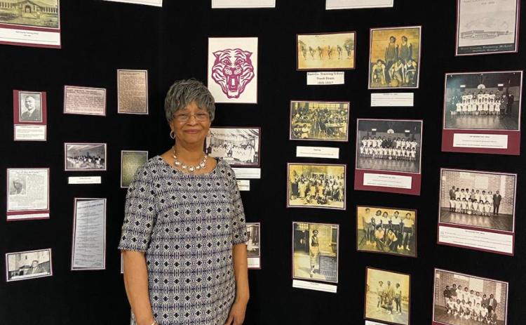Loretta King poses for a photo in February with the African-American history exhibit she put together at The Art Center.