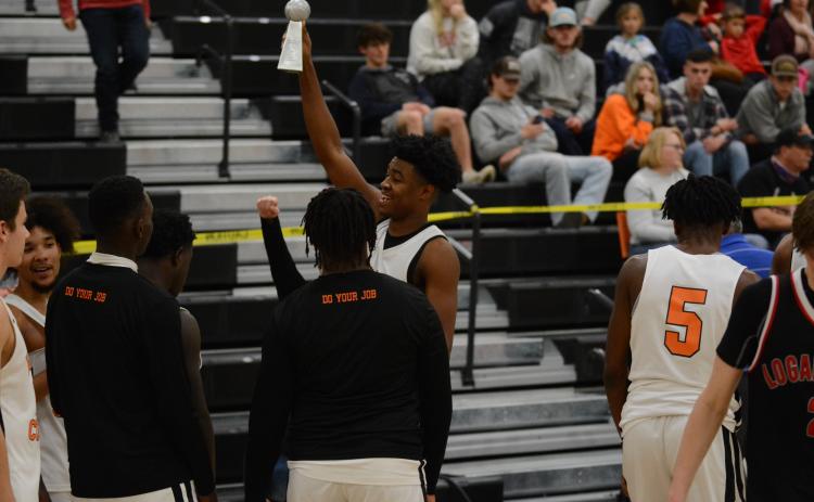 Sunshot by Grayson Williams - Hart County’s Tahj Johnson holds up the McDonald’s Shootout championship trophy at Hart County High School on Dec. 30.
