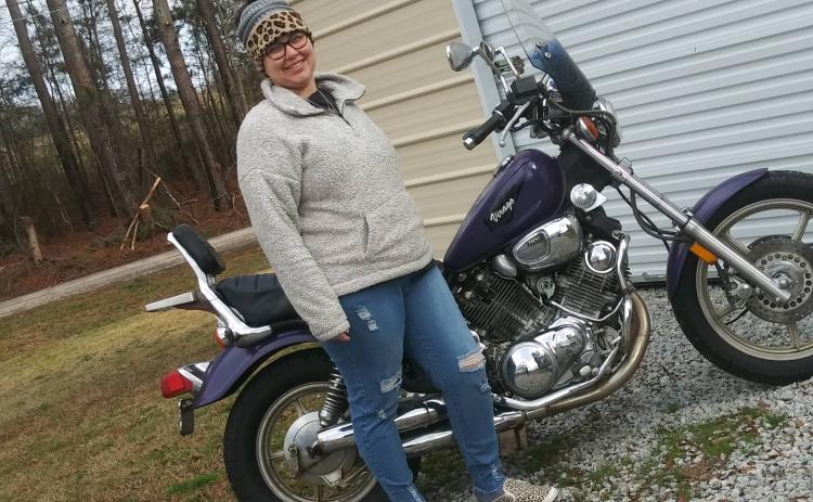 Brooke Dutton, event organizer for Women Ride, Women Build, poses with her bike.