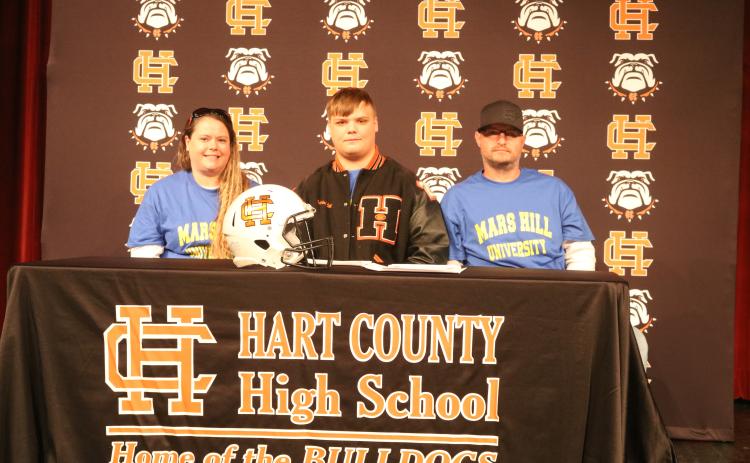 Sunshot by Grayson Williams Gabriel Coker, center, flanked by his mom, Amanda Morgan, and dad, Lee Morgan, signed last week to play college football at Mars Hill University.