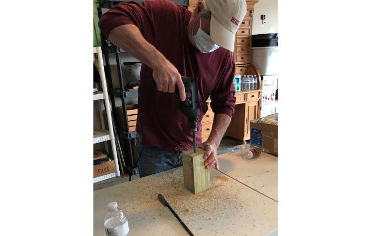Don Meyer, above, makes a carpenter bee trap for Golden K recently.