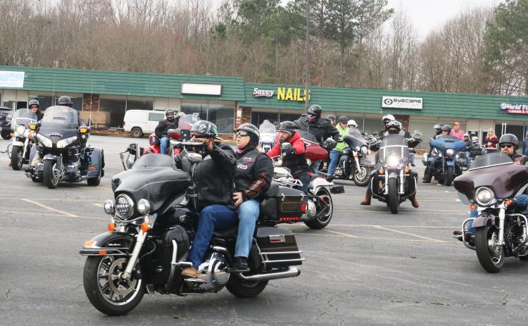 Motorcyclists leave the parking lot of the Quality Foods parking lot on Saturday, Feb. 27, for the Women Ride, Women Build motorcycle ride.