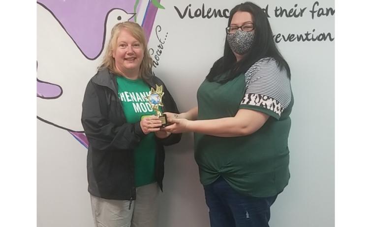 Photo submitted Sharon Swint, left, accepts a trophy recently from the Northeast Georgia Council on Domestic Violence representative Kayla Wilson for taking the Polar Bear Plunge for 25-straight years.