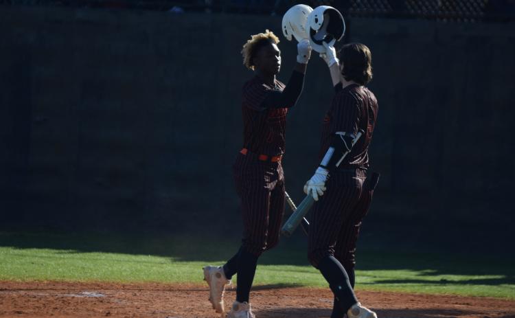Photo by Shane Scoggins/Franklin County Citizen Leader Hart County players Malachi Thomas, left, and Casey Tallent, right, bump helmets in celebration during a double-header on Friday, April 2 at Franklin County.