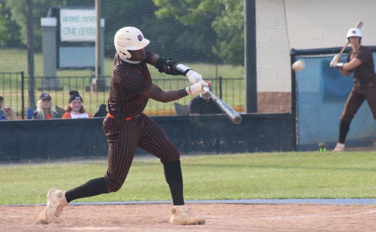 Sunshot by Grayson Williams - Paul Davis makes contact with a pitch on Friday, April 23 against Oconee County in Watkinsville.