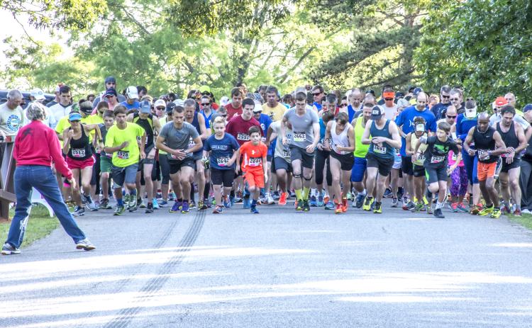 Runners in a past Dam Run prepare to take off at the starting line.