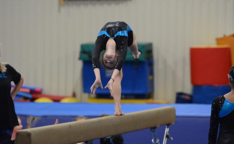 Sunshot by Grayson Williams Bella Beck bends backwards during her beam routine at the Bell Family YMCA on Friday, April 16.