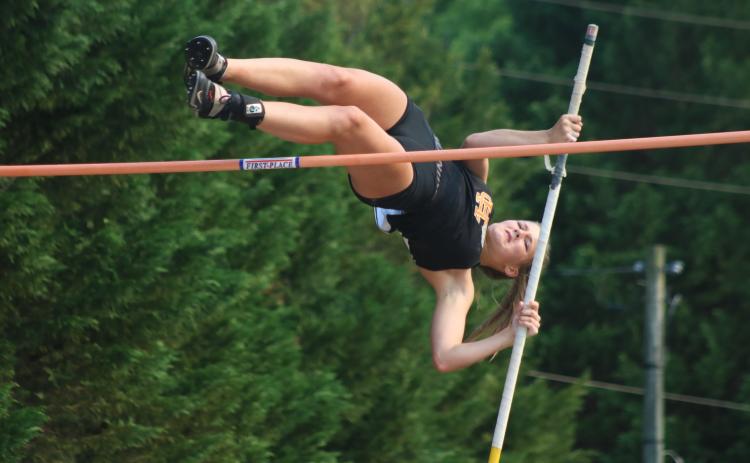 Sunshot from file - Hart County Freshman Amelia Johnson plunges herself into the air to clear the bar in the pole vault event on Tuesday, April 13 for senior night at Hart County High School. She earned eighth place at the Wingfoot Night of Champions.