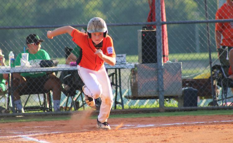 Sunshot from file - In a 2018 Little League All-Star tournament game, Kanyon Coulter sprints to first base after smacking a hit in the District 7 tournament where the Bulldogs earned first place.