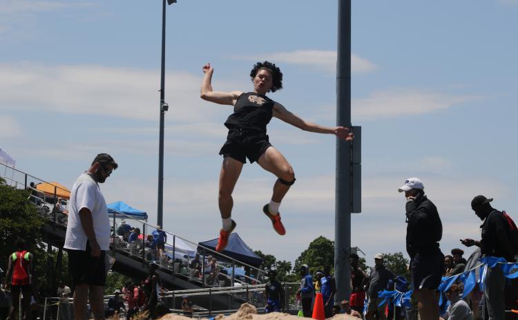 Marcus Etienne/ The Toccoa Record - Hart County’s J.C. Curry soars through the air during a field event in the sectional tournament at East Jackson on May 8.