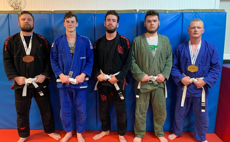 Photo submitted - Local jiu jitsu fighters, pictured from left to right, Chris Burns, Luke Didier, Jared Carswell, Chandler Howell and Alex Maxwell, all competed at and raised money for the Tap Cancer Out Brazilian Jiu Jitsu tournament on May 22 in Atlanta.