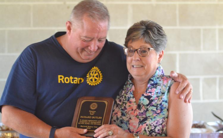 Dan Hunt/The Hartwell Sun - Rotary president Mike Everett hands Nancy Butler the Rotarian-of-the-Year Award. Butler was in attendance to accept the award on behalf of her late husband Dick, the most recent past president, who died June 1.
