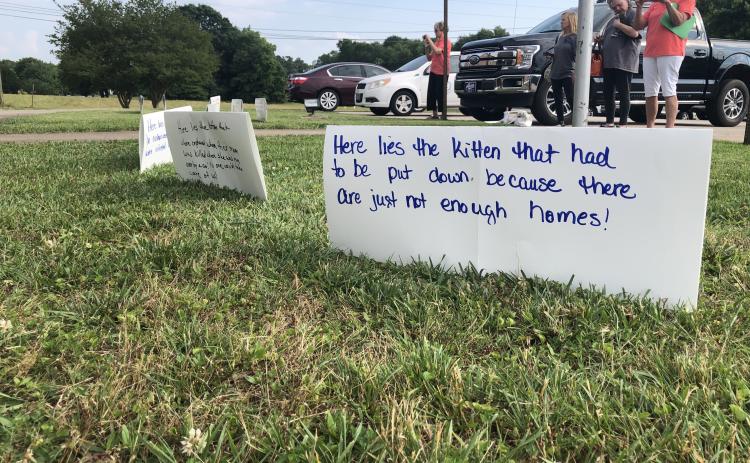 Grayson Williams/The Hartwell Sun - Residents and Humane Society reps set up signs in protest of the county’s current animal control ordinance.
