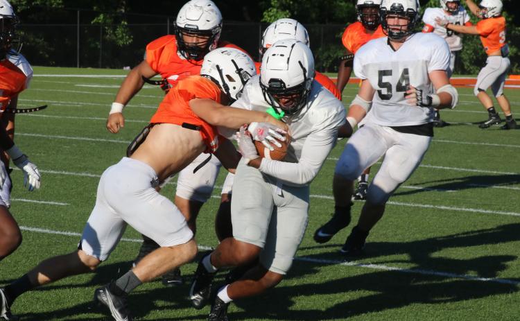 Sunshot by Grayson Williams Rising senior wide receiver Malachi Kelley tries to shake a defender as he grips the football after a catch in the Bulldogs’ spring game on Saturday, May 29 at Herndon Stadium.