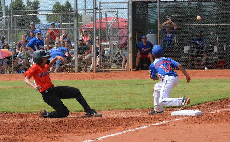 Drew Dotson/The Hartwell Sun - Axel Davis slides safe into third in his team’s win against Toccoa on June 27.