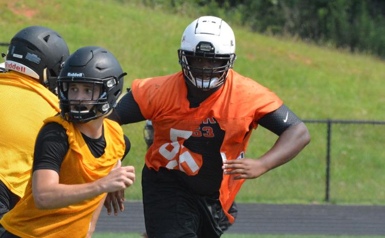 Derrick Clarke stalks a potential pass-catcher coming out of the backfield at the T.L. Hanna camp on July 22.
