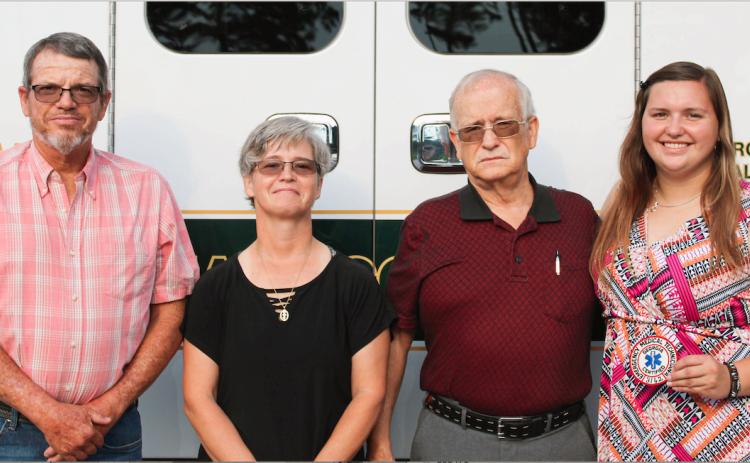 Josh Brannen/The Hartwell Sun - Russell Cooper (far left), Brandi Cooper (center left), Randall Dean Graham (center right), and Morgan Cooper (far right), all EMT’s, stand in front of an ambulance.
