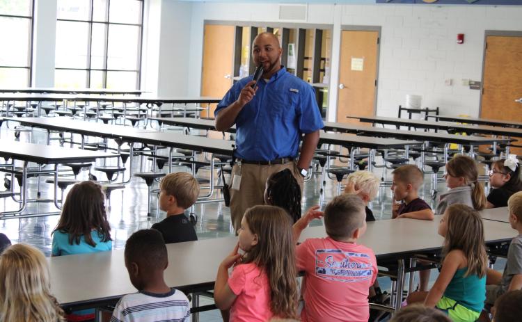 Vice principal Steve Burton talks to students at North Hart Elementary.