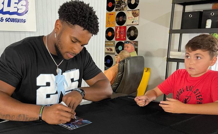 Photo Submitted Kaimon Rucker signs autographs for fans at Lake Hartwell Collectibles on July 31.
