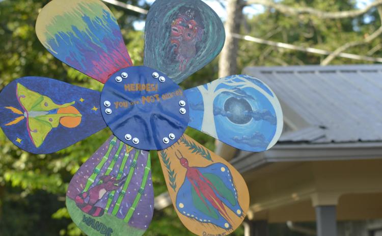 The five-foot tall sculpture features painting work from seven artists, including unique designs on each of the daisy’s six petals.