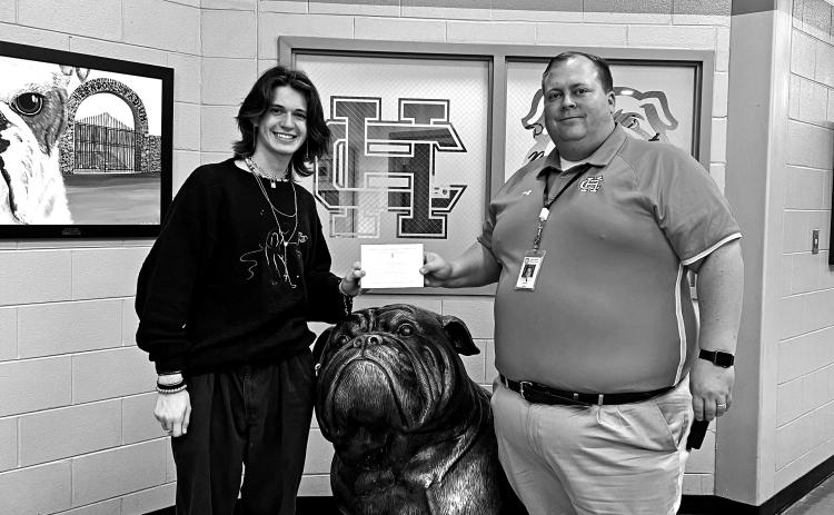 Principal Kevin Gaines presents student Ethan McDowell with his commended student designation.