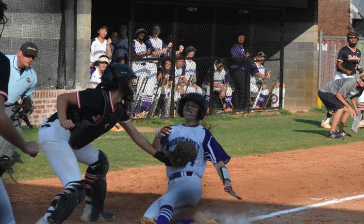 Marlee Harris tags  Monroe Area base-runner out at home on Sept. 10.