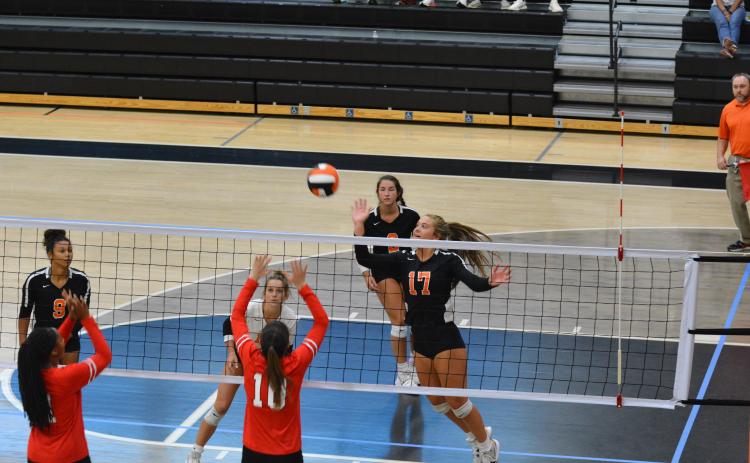 Dakota Phillips (17) taps the ball over the net against Stephens County.