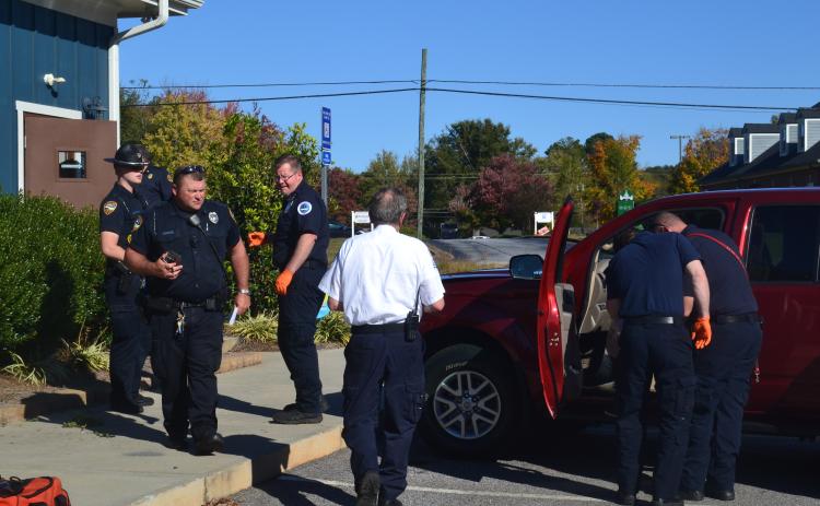 Investigators in first responders check out the scene Monday after a 95-year-old woman drove into the side wall of Hartwell Animal Hospital at 60 Leard Street.