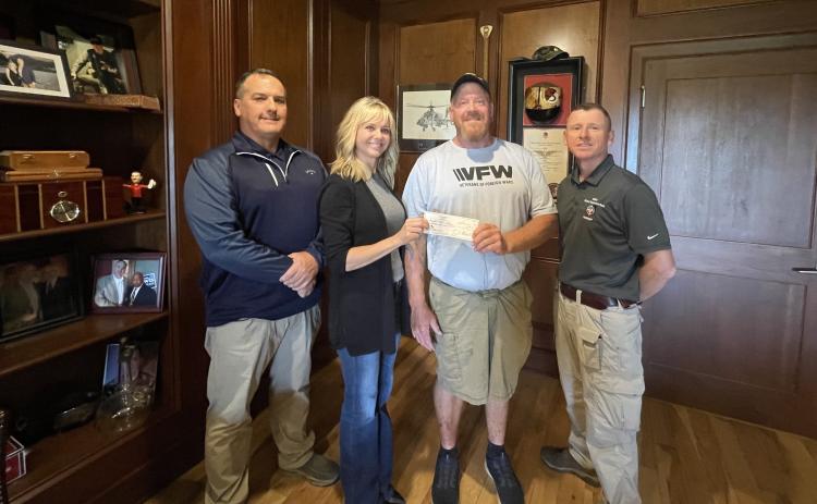 From left to right: Eric Mcallister, post quartermaster; Kelli Schell, chair of the Toughest Kids Board of Directors; Patrick Wireman, post commander and Jud Turpin, post trustee.