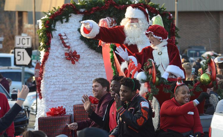 Santa, Mrs. Claus and several float-riders wave to the crowd at the 2019 Hartwell Christmas Parade.