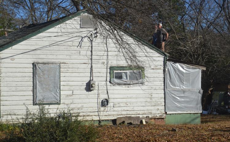 Contractors renovate a roof at 150 Rome Street on Monday, Dec. 13 as part of Habitat for Humanity’s plan to renovate homes in Rome and Richardson.
