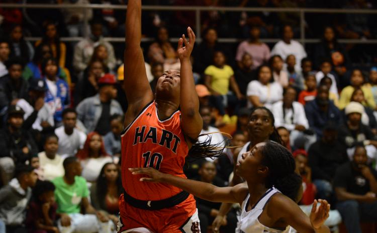 Pashay Saddler shoots off the rebound over the Elbert County defender on Dec. 17 in Elberton.