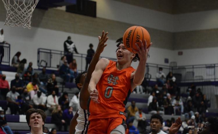 Johnny Curry fights through traffic to get the layup against Monroe Area on Friday, Jan. 7.